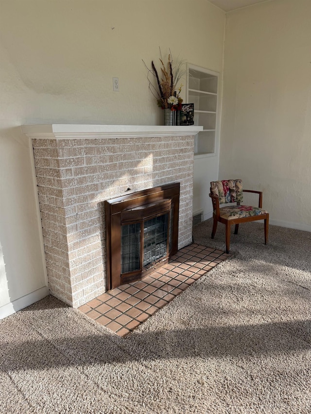 interior space featuring built in features, carpet flooring, a fireplace, and visible vents