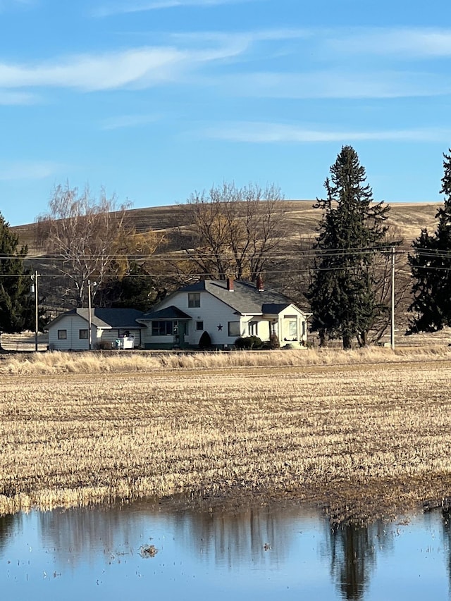 exterior space with a rural view and a water view