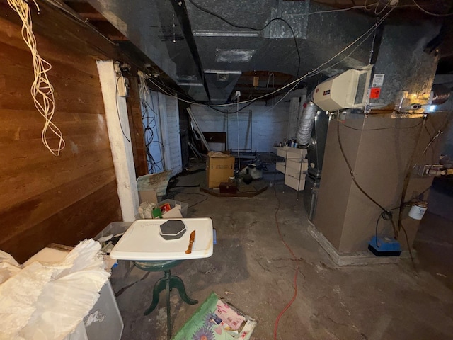 unfinished basement featuring wood walls