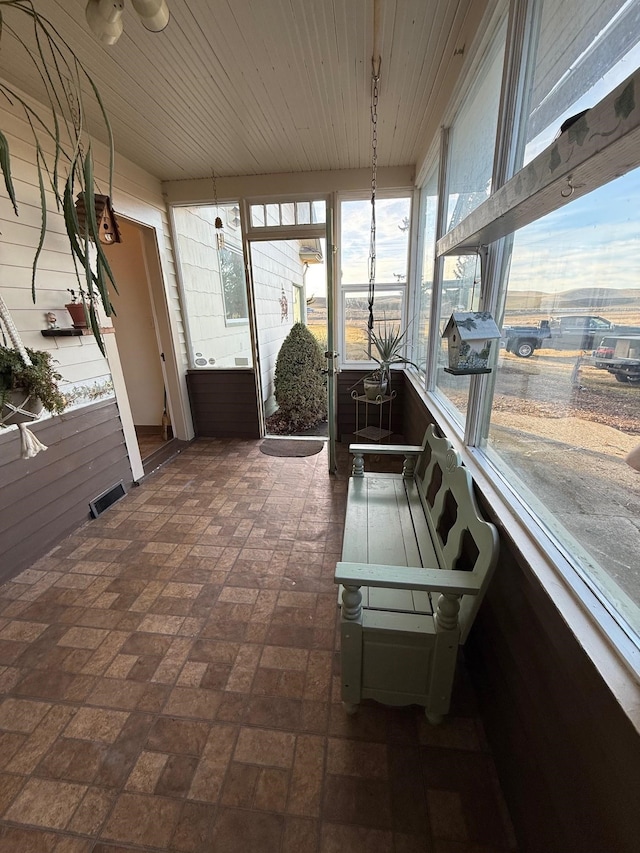 sunroom featuring wooden ceiling and visible vents