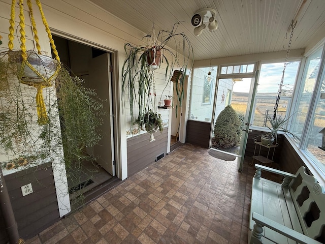 unfurnished sunroom with a wealth of natural light and wooden ceiling