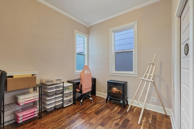 office featuring ornamental molding, a wood stove, baseboards, and wood finished floors