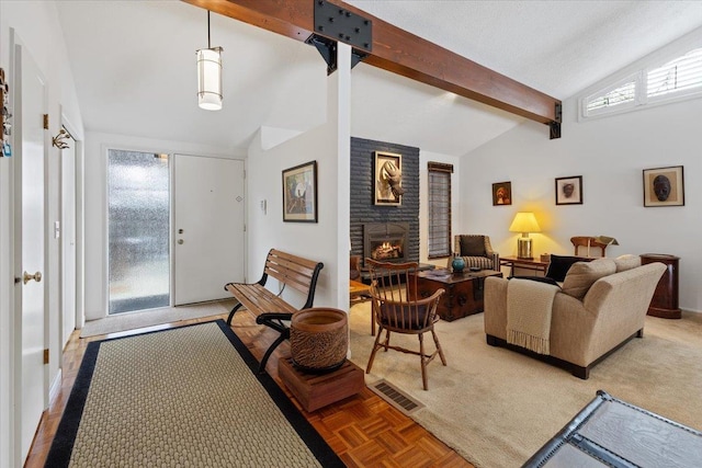 foyer entrance with visible vents, a fireplace, and lofted ceiling with beams