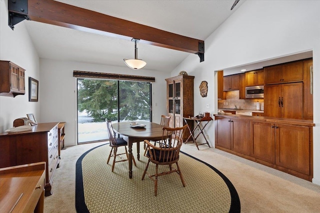 dining room with high vaulted ceiling, light carpet, and beamed ceiling