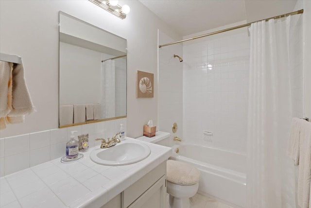 bathroom with toilet, shower / tub combo with curtain, and vanity