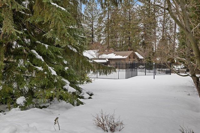 yard layered in snow with fence