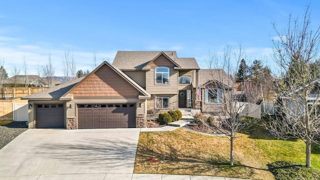 craftsman-style home with a garage, fence, concrete driveway, stone siding, and roof with shingles