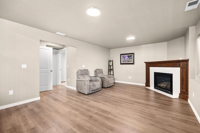 unfurnished room with light wood-style floors, baseboards, and visible vents