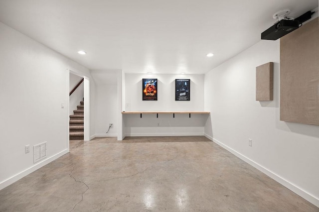 finished basement with recessed lighting, visible vents, baseboards, and stairs