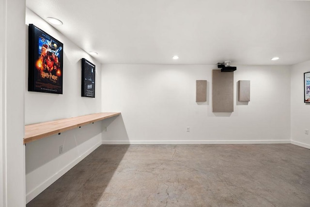 interior space featuring concrete flooring, recessed lighting, and baseboards