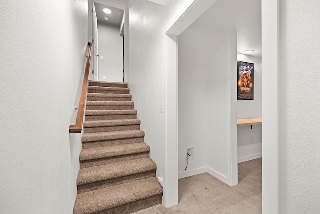 staircase featuring baseboards