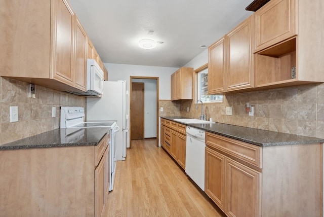 kitchen featuring white appliances, light wood-type flooring, a sink, and tasteful backsplash