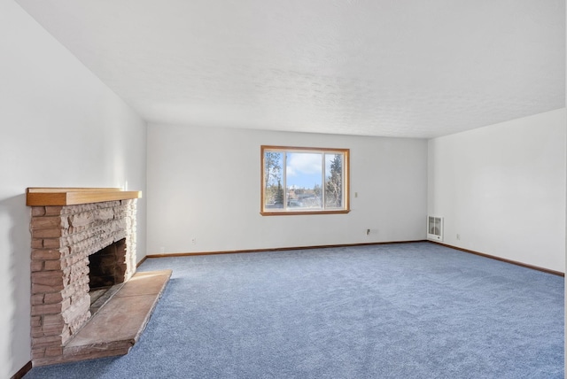 unfurnished living room with a fireplace, baseboards, and carpet flooring