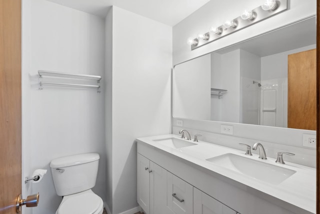 full bathroom featuring a sink, toilet, and double vanity