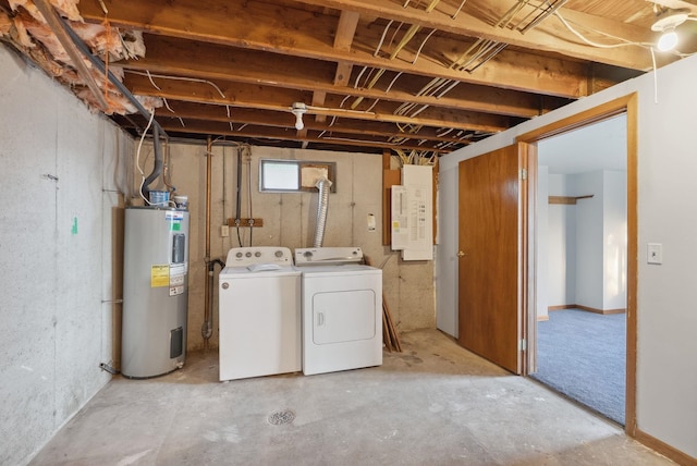 basement with electric panel, washer and clothes dryer, and electric water heater