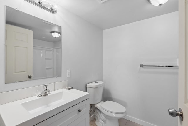 full bathroom with toilet, tile patterned floors, baseboards, and vanity