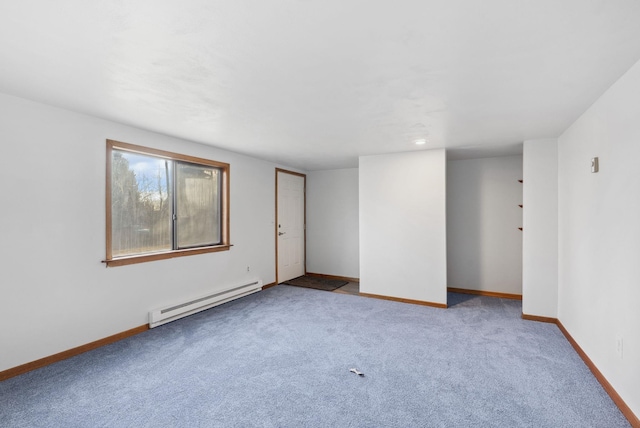 unfurnished room featuring a baseboard radiator, baseboards, and carpet flooring