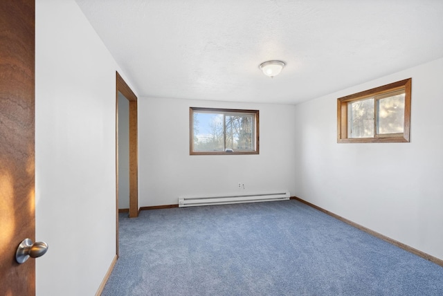 unfurnished room with a textured ceiling, carpet floors, baseboard heating, and baseboards