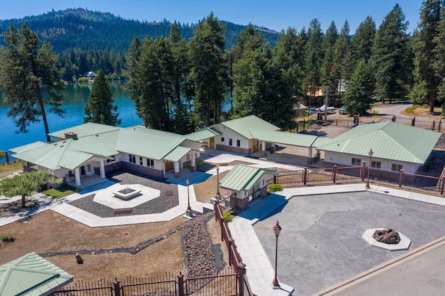 drone / aerial view featuring a water view and a view of trees