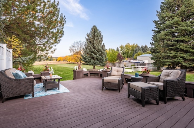 deck with fence, an outdoor living space, and a lawn