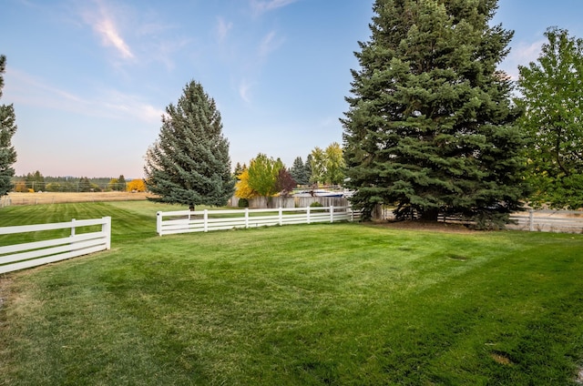 view of yard featuring a rural view and fence