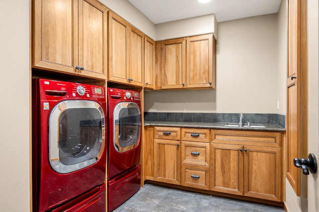 laundry area featuring washer and dryer, cabinet space, and a sink