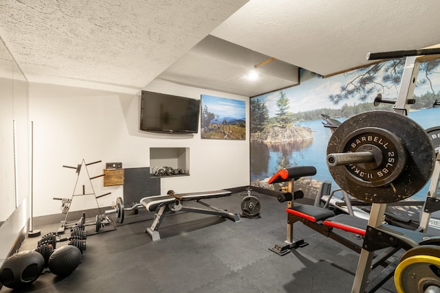 workout area with floor to ceiling windows, a textured ceiling, and baseboards