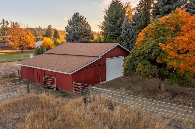 exterior space with driveway, an exterior structure, and an outbuilding