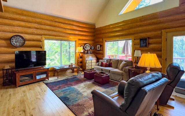 living room featuring log walls, high vaulted ceiling, and hardwood / wood-style flooring