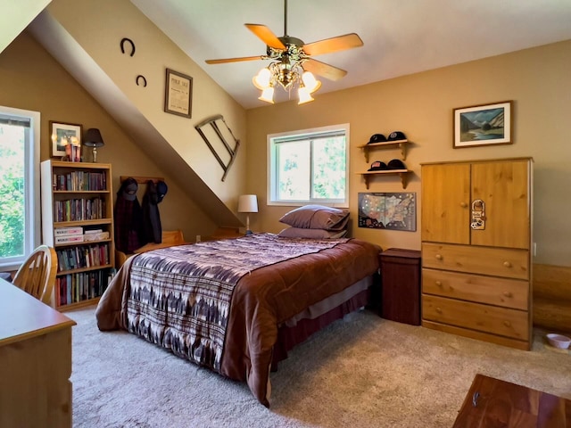 bedroom featuring vaulted ceiling, carpet flooring, and a ceiling fan