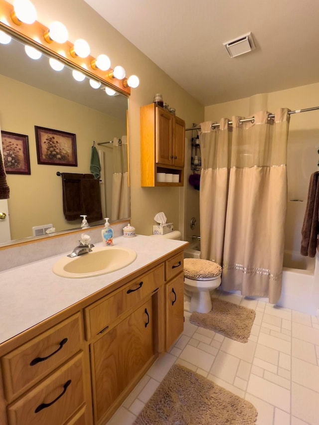 bathroom featuring visible vents, vanity, toilet, and shower / bath combo with shower curtain