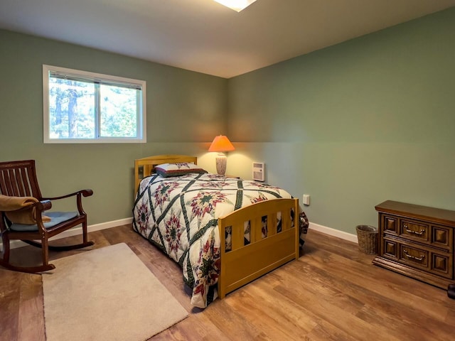 bedroom with wood finished floors and baseboards