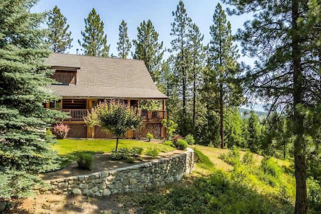 view of property exterior featuring a yard and a wooden deck