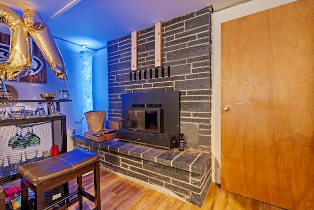 living room featuring wood finished floors and a glass covered fireplace