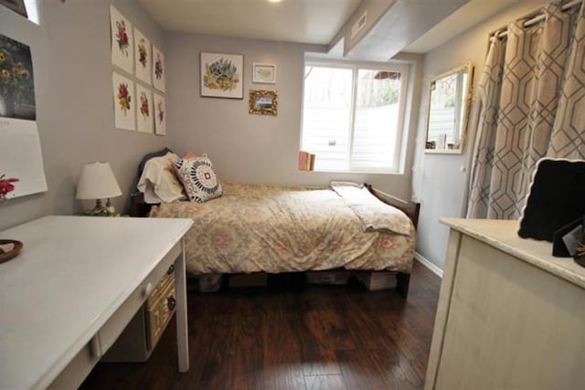 bedroom featuring dark wood-style flooring