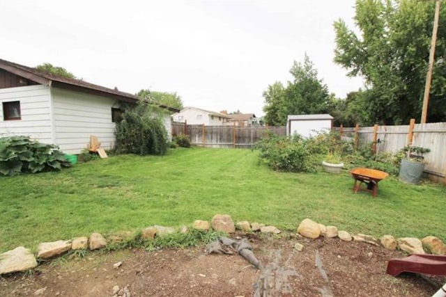 view of yard featuring an outbuilding and a fenced backyard