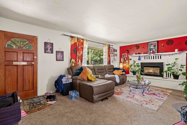 living area with a brick fireplace and carpet flooring