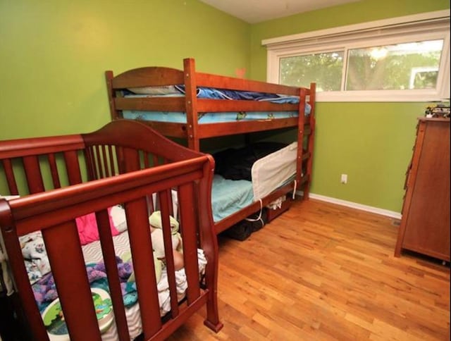 bedroom featuring wood finished floors and baseboards