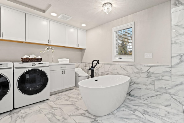 clothes washing area with cabinet space, visible vents, independent washer and dryer, marble finish floor, and recessed lighting