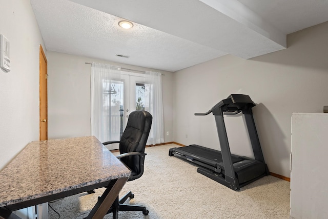 carpeted home office featuring french doors, visible vents, a textured ceiling, and baseboards