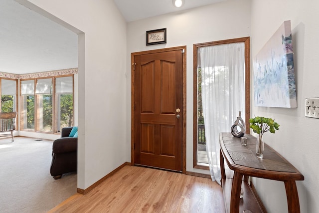 entryway featuring light wood finished floors and baseboards