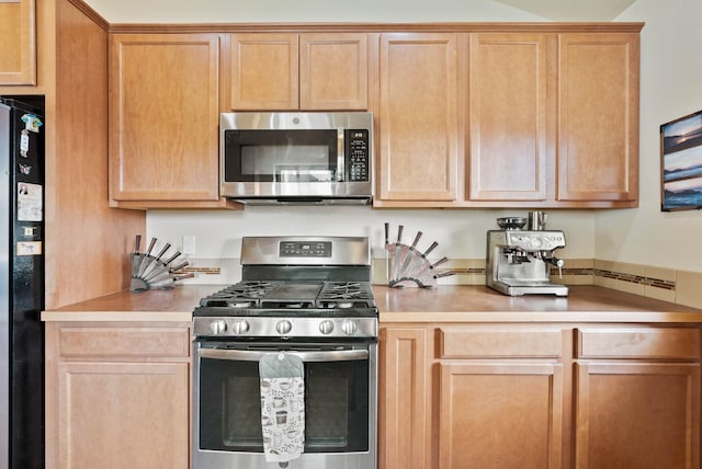 kitchen featuring stainless steel appliances and light countertops