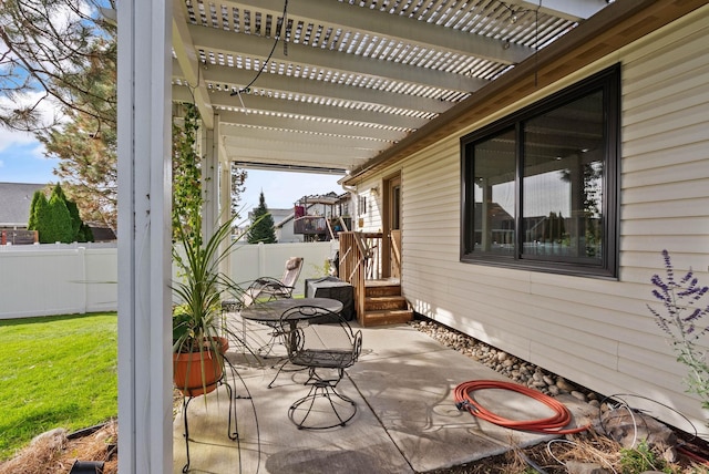 view of patio with outdoor dining space, fence, and a pergola