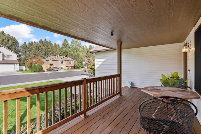 deck with a residential view, a porch, and a lawn