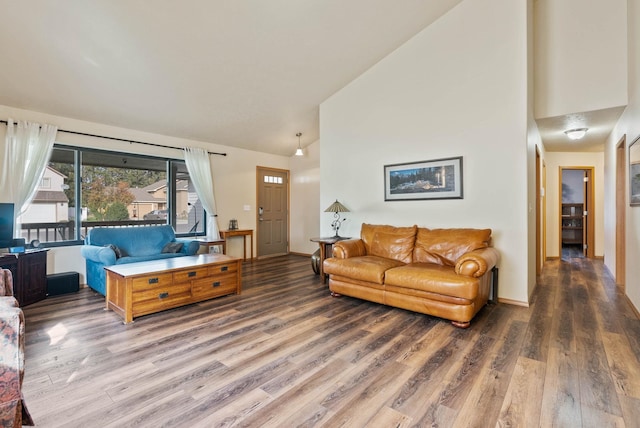 living room with high vaulted ceiling, baseboards, and wood finished floors