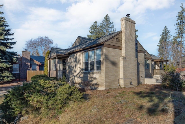 view of home's exterior featuring brick siding and a chimney