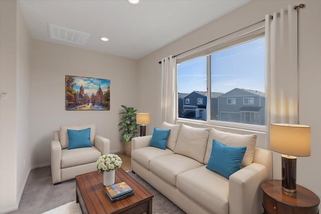 living room featuring carpet, visible vents, baseboards, and recessed lighting