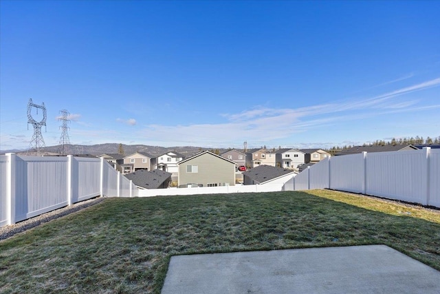 view of yard featuring a residential view and a fenced backyard