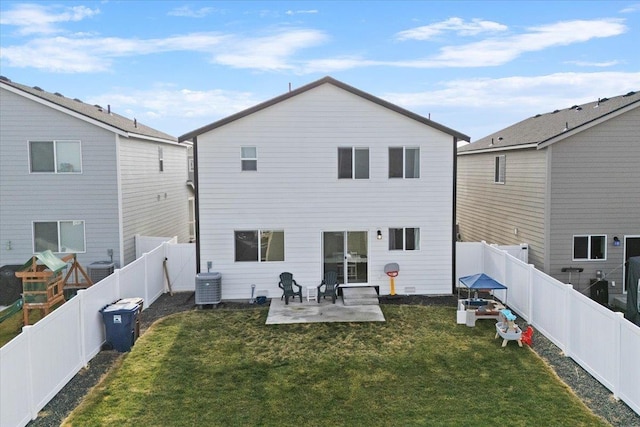 rear view of house featuring a fenced backyard, a yard, central AC, and a patio