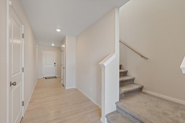 interior space with baseboards, wood finished floors, and recessed lighting